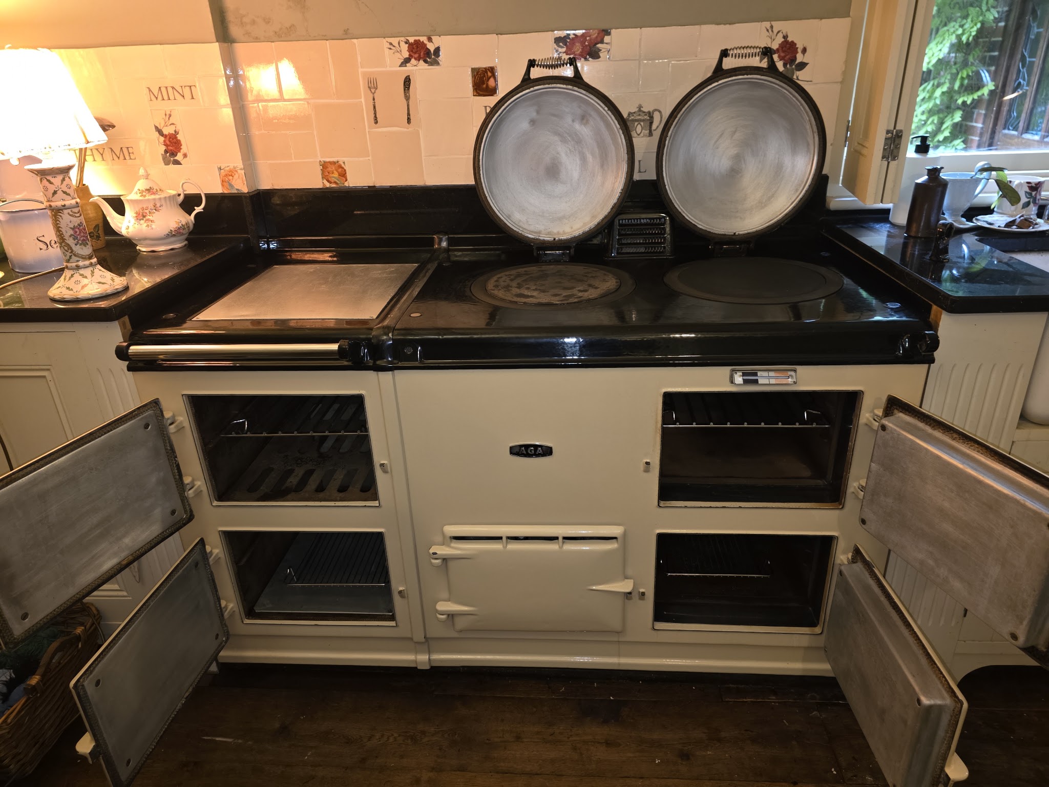 A cream Aga with all of its oven doors open after a deep clean