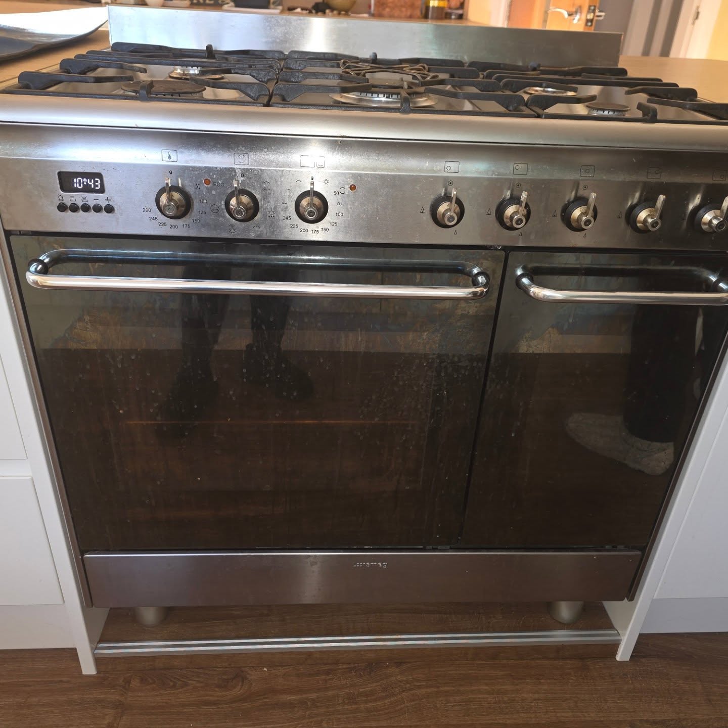 A stainless steel Smeg range cooker with clean glass doors